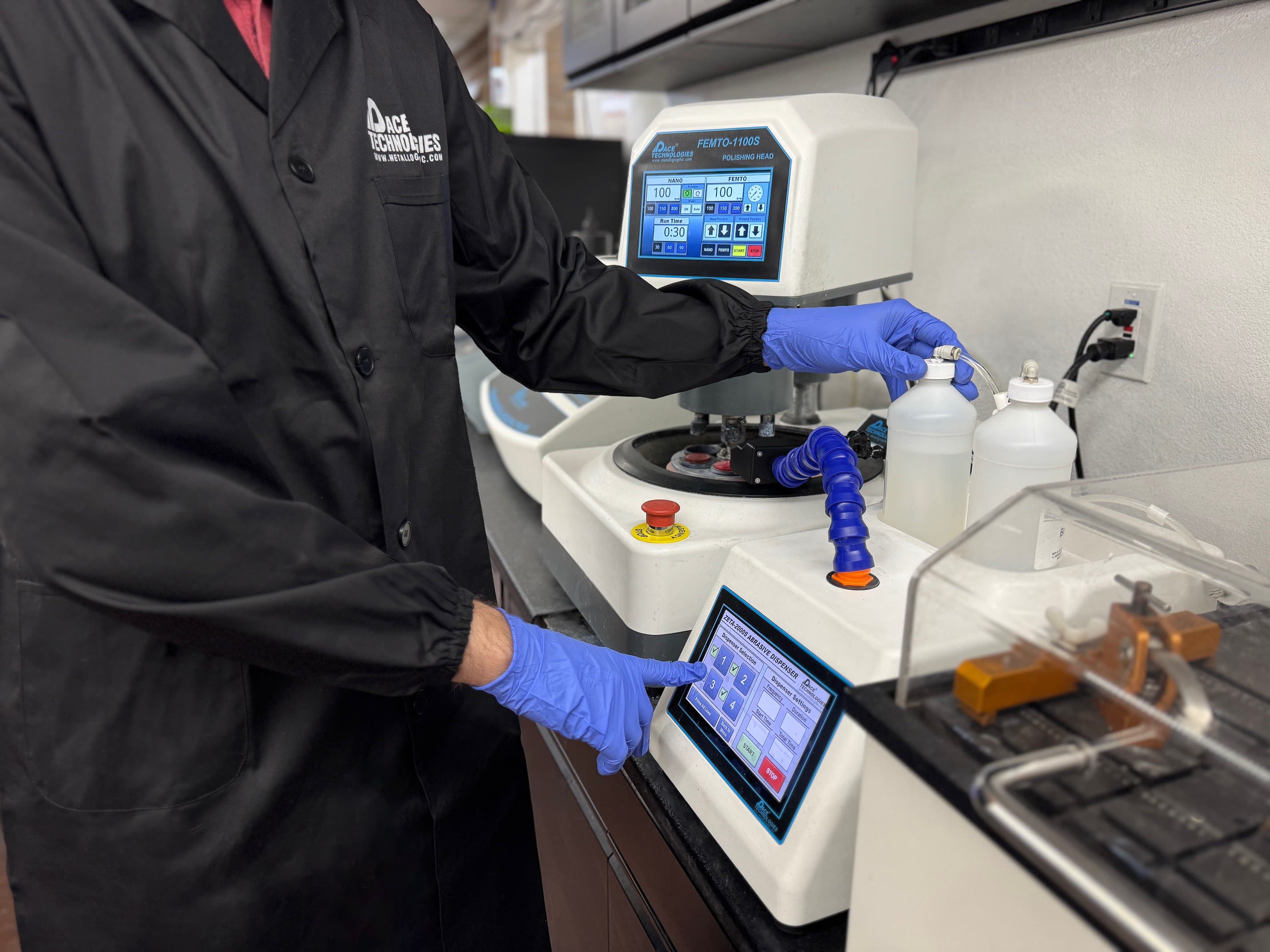 Metallography expert using sample preparation equipment Metallography technician working with sample preparation equipment including grinding polishing machines for metallographic analysis